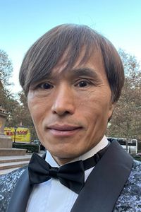 Photo of Joe Alny, looking mildly surprised, in a tuxedo with a black bowtie